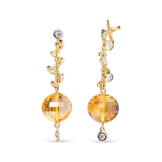 Front-facing view of a pair of yellow metal drop earrings featuring round bezel-set white and brown gemstones along the chain and a large faceted yellow gemstone with drilled setting at the bottom.