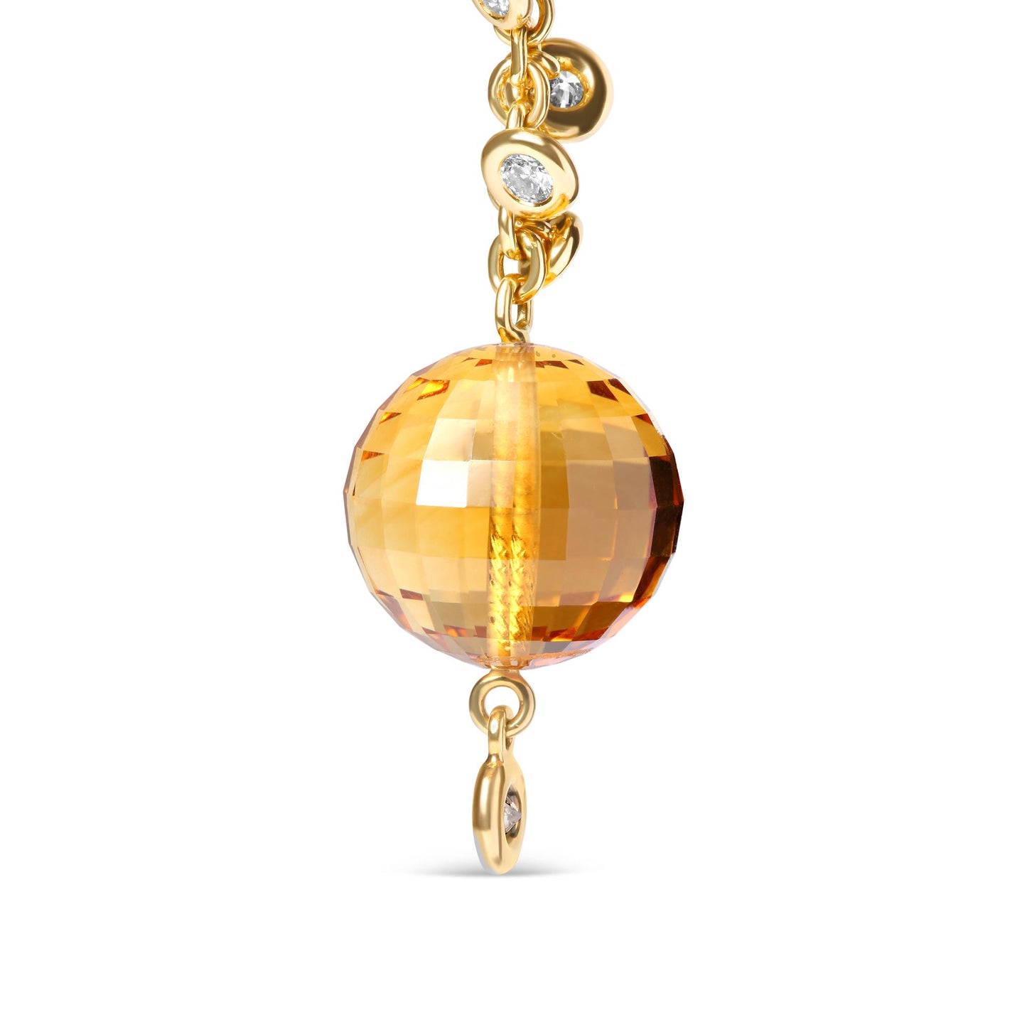 Close-up front view of yellow metal dangle earring featuring a large faceted yellow gemstone sphere suspended from a chain adorned with small bezel-set round white and brown gemstones.