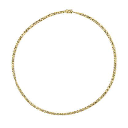 Top-down view of a yellow metal chain necklace laid flat in a circular shape against a white background.