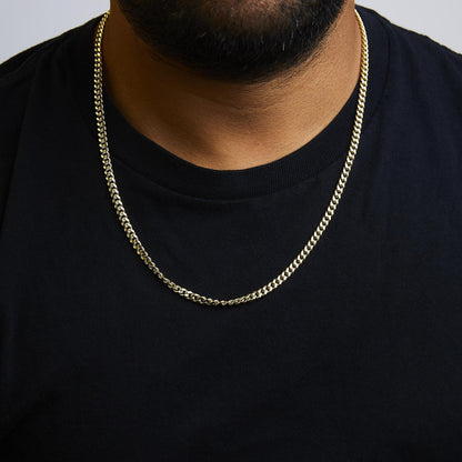 Yellow metal chain necklace shown worn on a model, front-facing close-up shot.