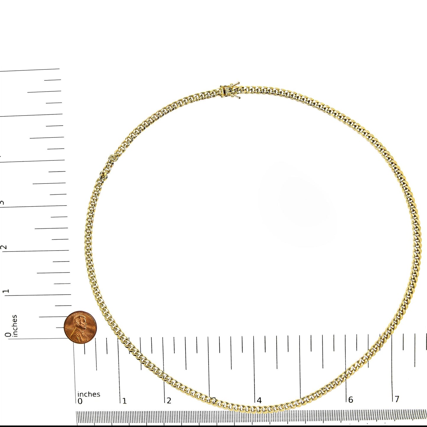 Top-down view of a yellow chain necklace displayed on a ruler and scale for size reference.