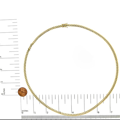 Top-down view of a yellow chain necklace displayed on a ruler and scale for size reference.