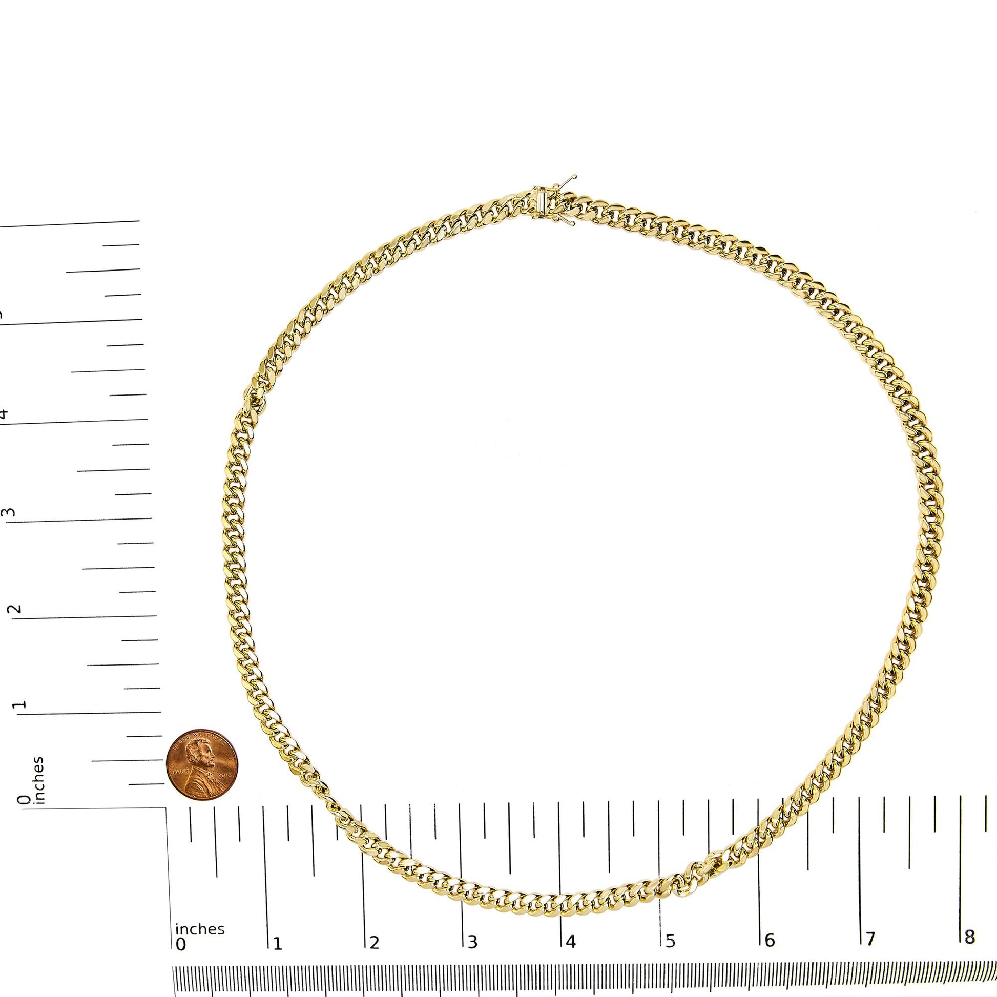 Yellow chain necklace laid flat on a white surface with rulers and a coin for size reference, shot from above.
