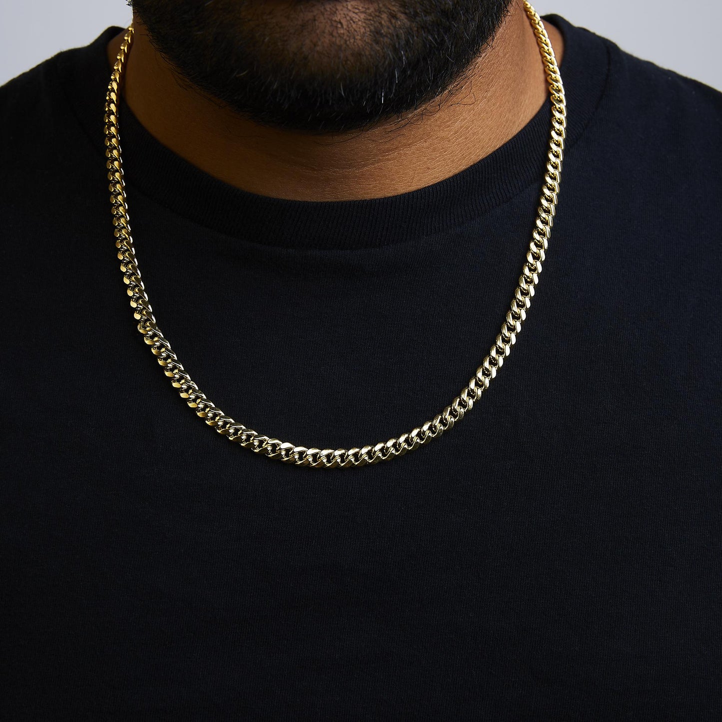 Yellow metal chain necklace shown worn on a model, front angle view.