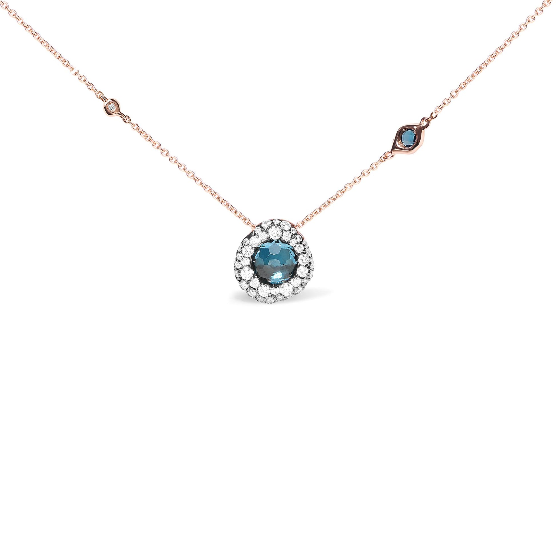 Rose metal necklace with a round blue gemstone pendant surrounded by white gemstones, and additional small white and blue gemstones spaced along the chain, shown from a front angle.