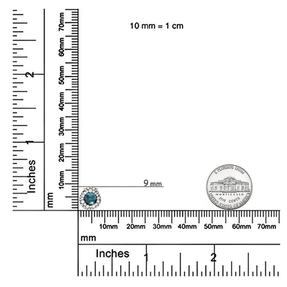 Rose metal necklace pendant with a round blue gemstone in bezel setting surrounded by small round white gemstones in prong setting, shown on a ruler for size reference.