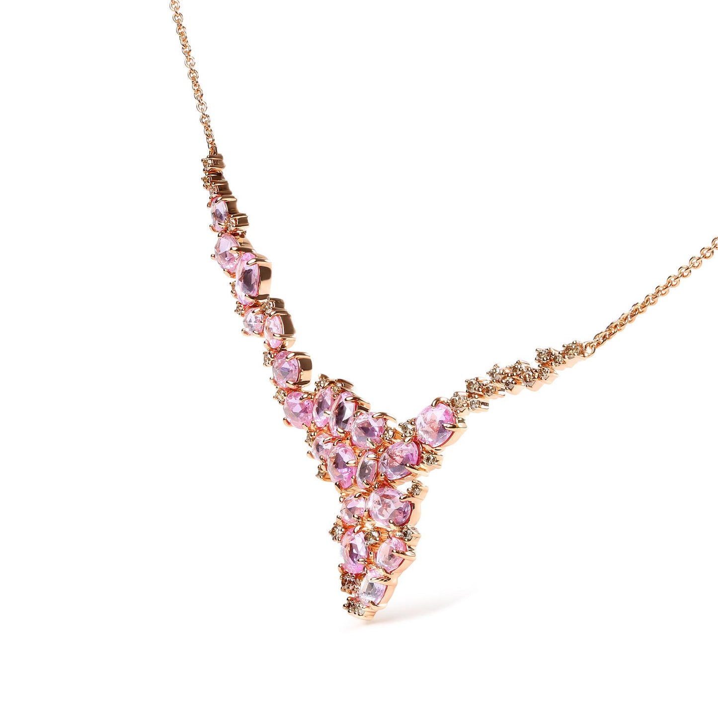 Close-up angle of a rose metal necklace featuring oval pink gemstones and round brown gemstones in prong settings.