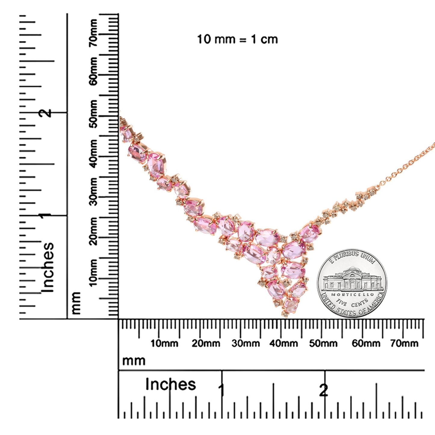 Rose metal necklace with pink oval gemstones and brown round gemstones in prong settings, displayed on a ruler and coin for size reference, angled diagonally.