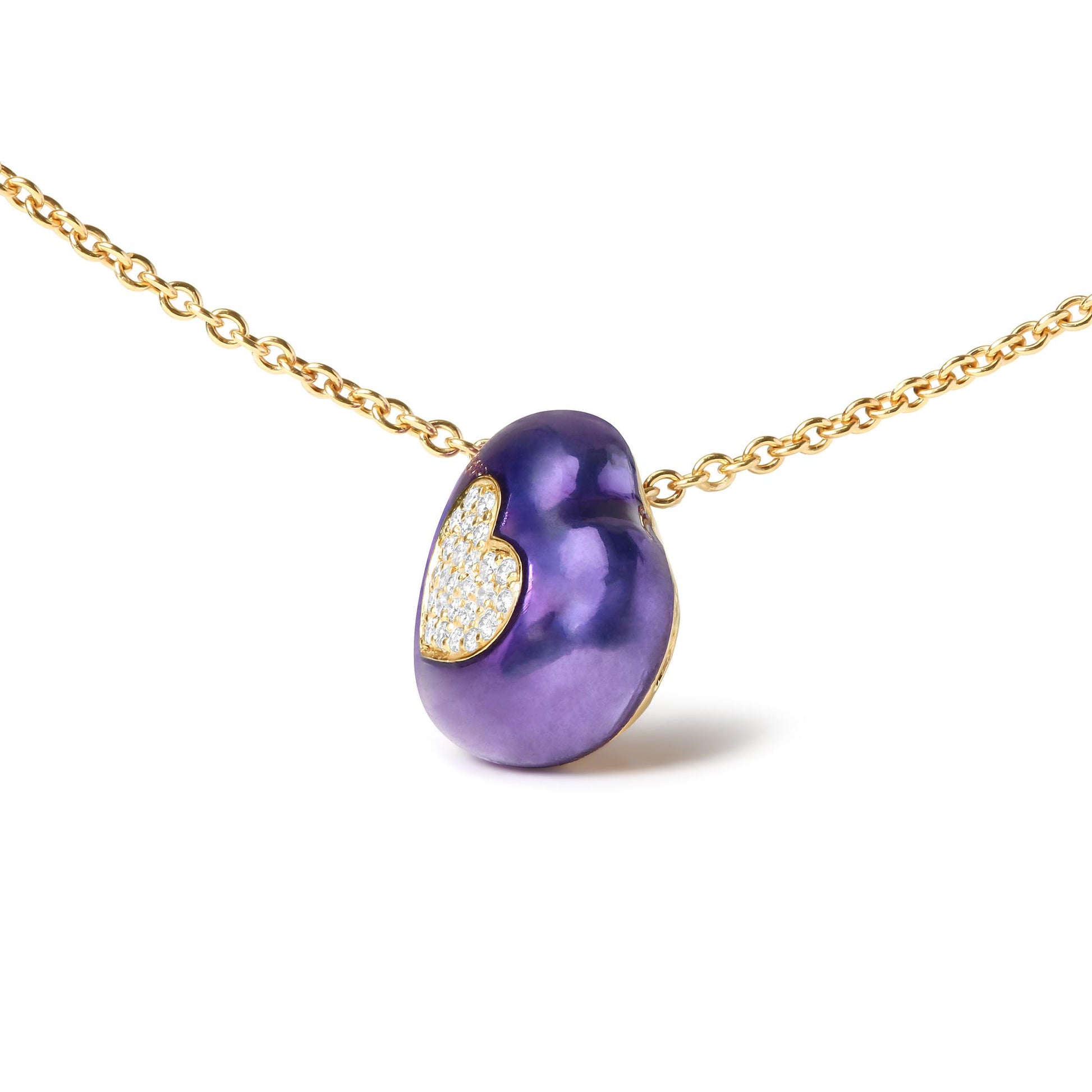 Close-up front angle of a yellow metal chain necklace with a purple bean-shaped pendant featuring a heart-shaped section set with white round pave gemstones.