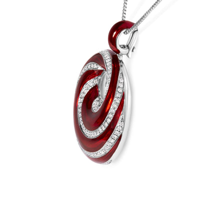 Close-up side angle of a white metal necklace pendant with red enamel and swirling rows of round white gemstones in prong settings.