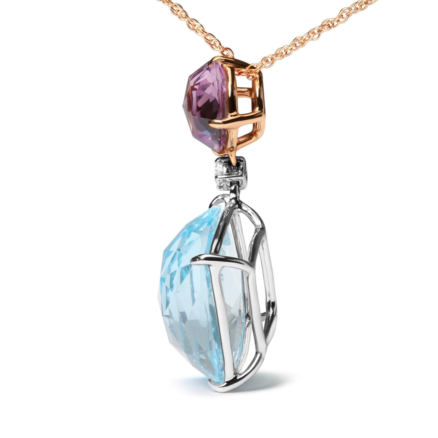 Close-up side angle of a white and rose metal necklace pendant featuring a large blue cushion-shaped gemstone, a smaller pink round gemstone, and a small white round gemstone.