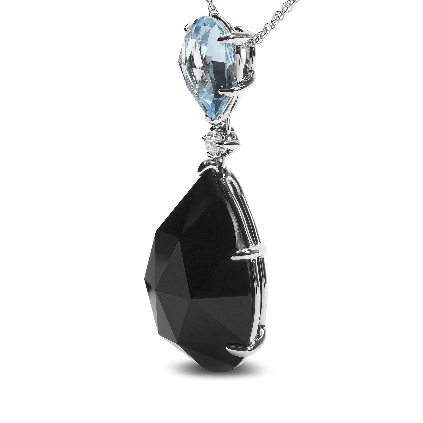 Close-up front view of a white metal necklace pendant featuring a prong-set blue pear-shaped gemstone on top, a small round white gemstone below it, and a larger prong-set black pear-shaped gemstone at the bottom.