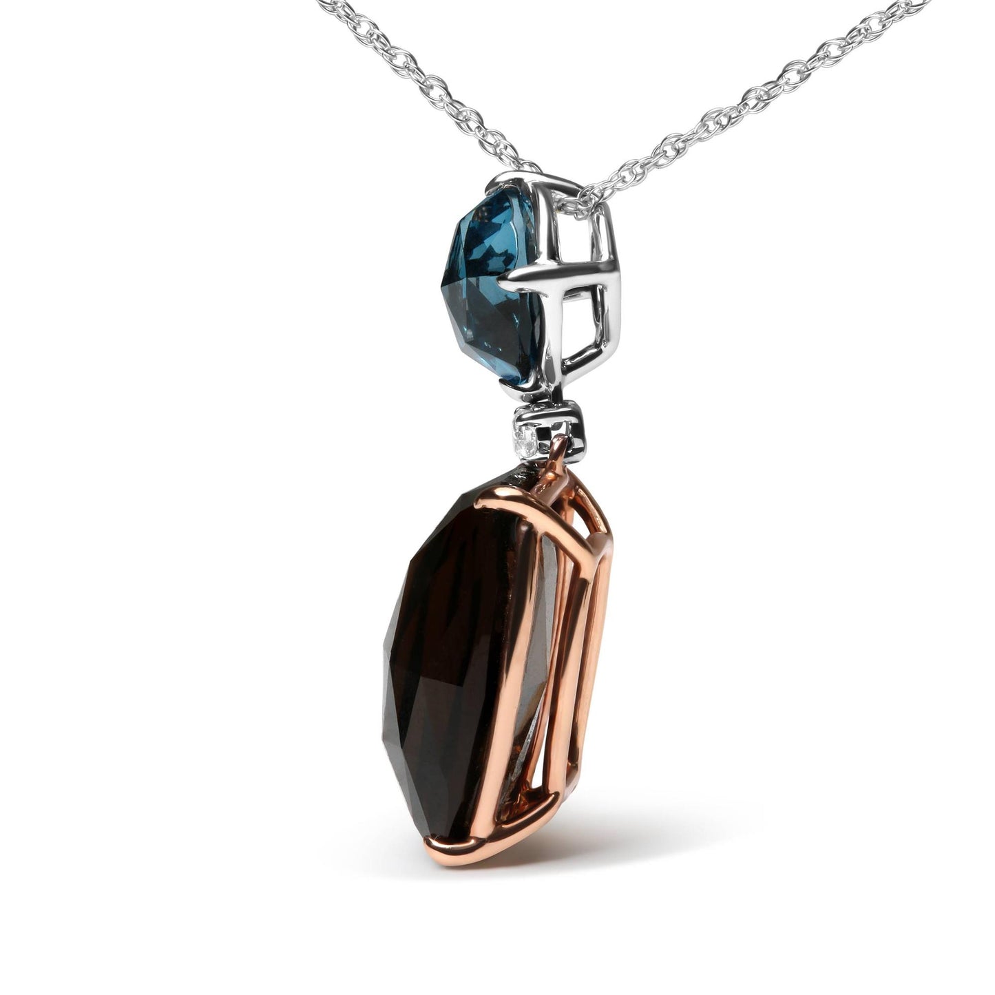 Close-up side angle of a two-tone necklace pendant featuring a cushion-shaped smoky gemstone set in rose-colored metal prongs, a small round white gemstone above it, and a round blue gemstone set in white metal prongs at the top.