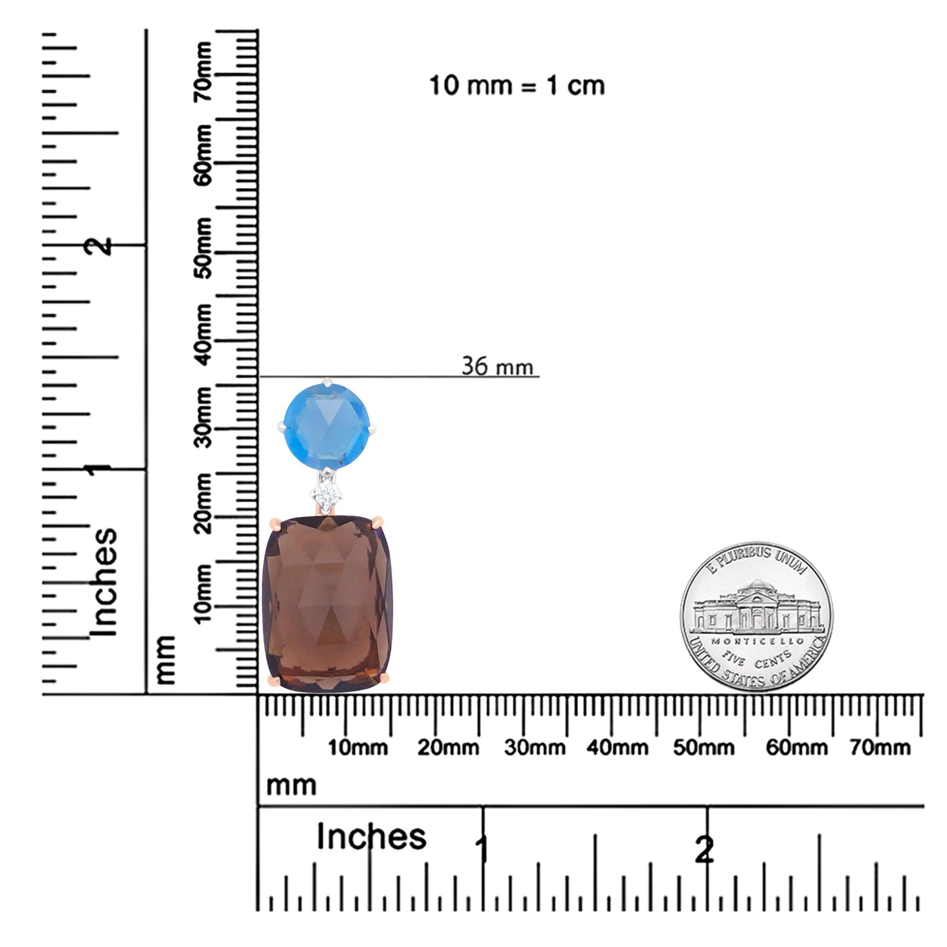 Necklace pendant with a large smoky cushion-shaped gemstone, a small white round gemstone, and a blue round gemstone, displayed on a ruler and alongside a coin for size reference, top-down angle.