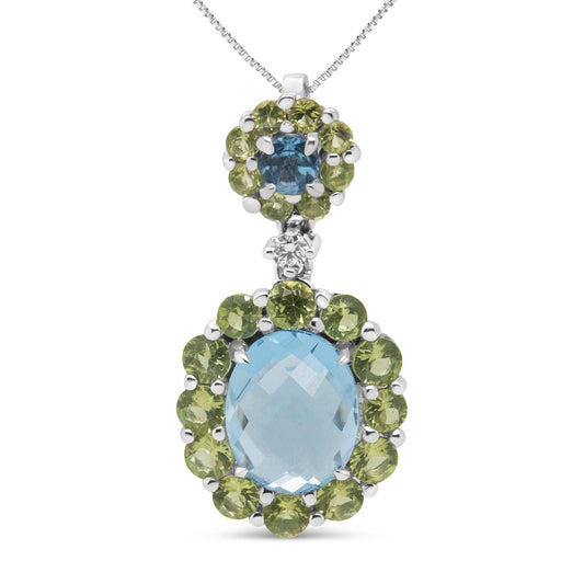Front view of white metal necklace pendant featuring a large oval blue gemstone surrounded by round green gemstones, a smaller cluster above with a round blue gemstone surrounded by round green gemstones, and a single white gemstone connecting the two clusters.