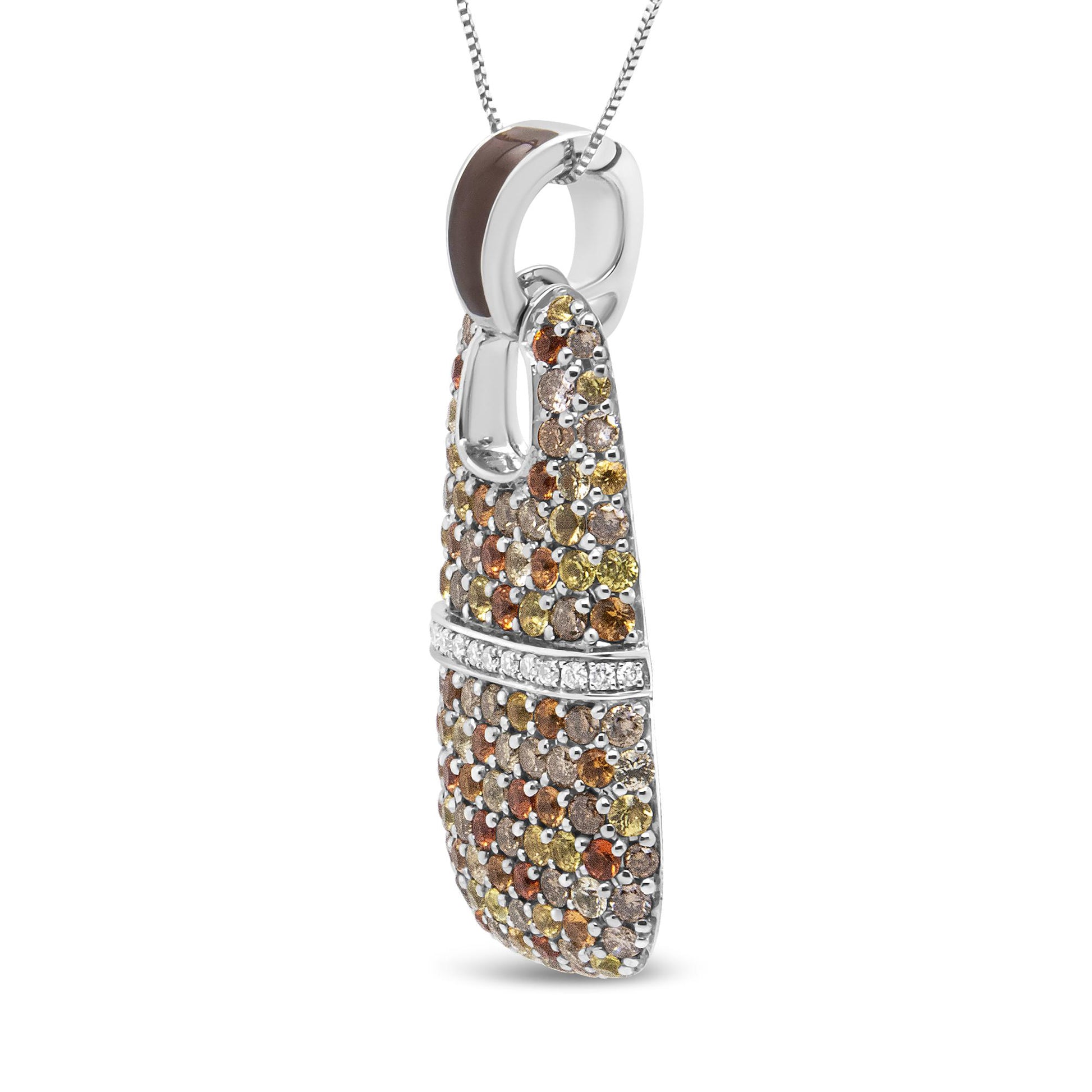 White metal necklace pendant with curved rectangular shape, covered in round red, yellow, and brown gemstones in prong settings, accented by a horizontal row of round white gemstones in shared prong setting. Pendant shown from a side angle with chain threaded through the top loop.
