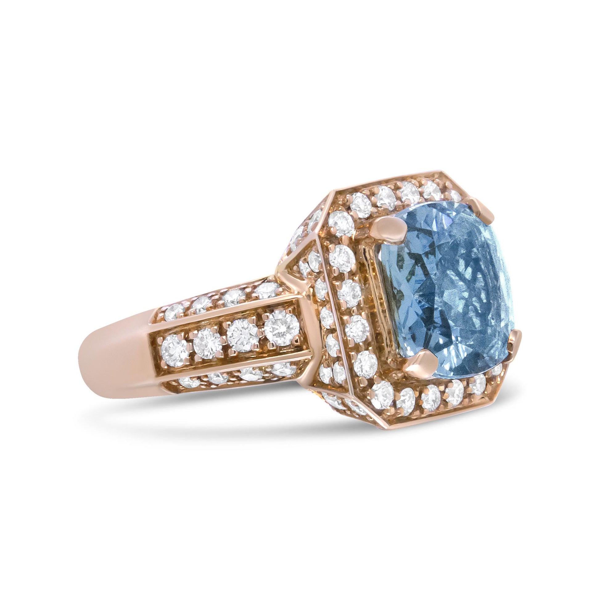 Yellow metal ring with a cushion-shaped blue gemstone center and multiple round white gemstones surrounding the center and along the band, shown at a side angle.