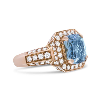 Yellow metal ring with a cushion-shaped blue gemstone center and multiple round white gemstones surrounding the center and along the band, shown at a side angle.