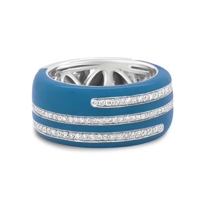 Close-up front angle of a white metal ring with a blue enamel outer band featuring three rows of round white gemstones in pave setting.