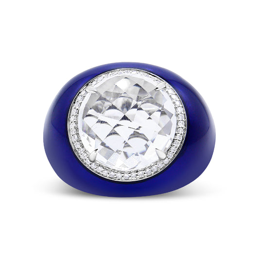 Front-facing view of a white ring featuring a large round white gemstone in a bezel setting, surrounded by a circle of small round white gemstones in a shared prong setting, set on a blue band.