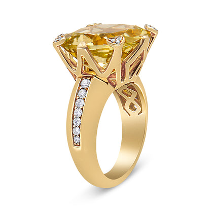 Side angle view of a yellow ring featuring a large cushion-shaped lemon-colored gemstone in a prong setting, accented with multiple round white gemstones on the band and prongs.