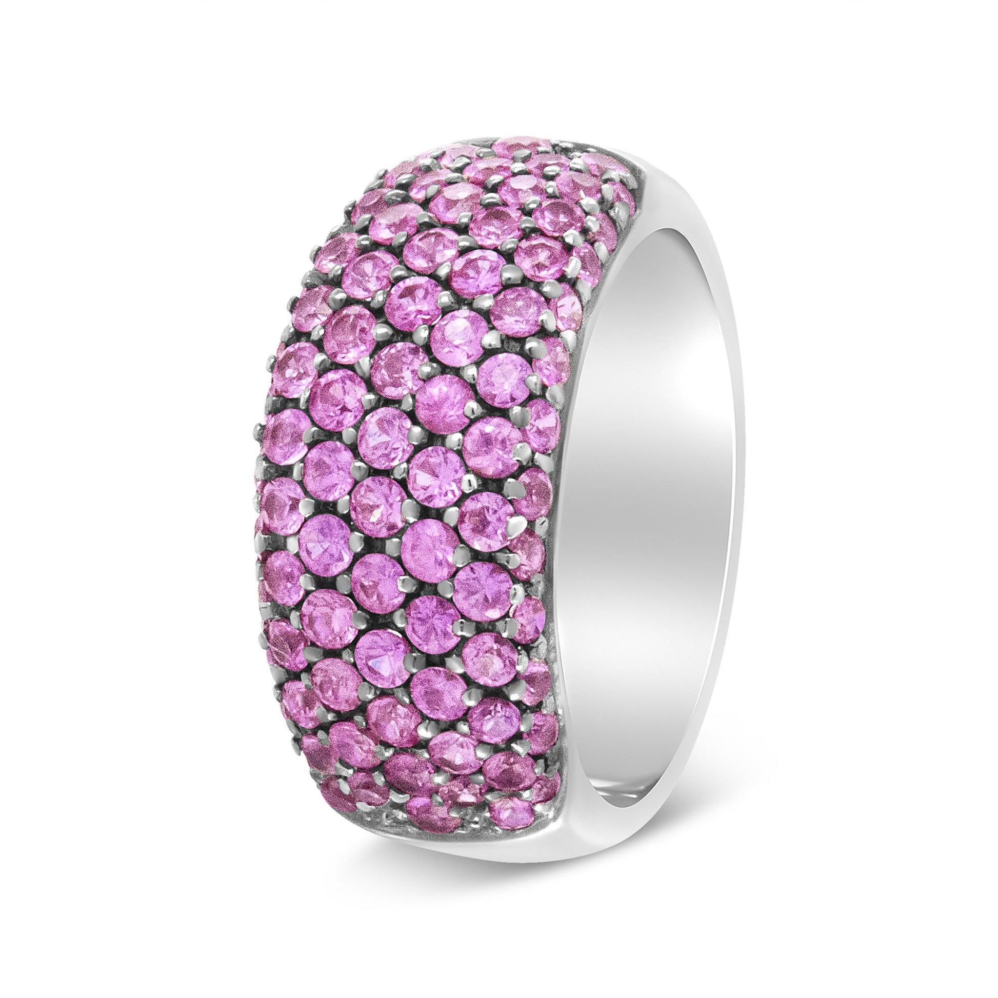White metal ring with multiple round pink gemstones in prong settings, shown at a slight side angle.