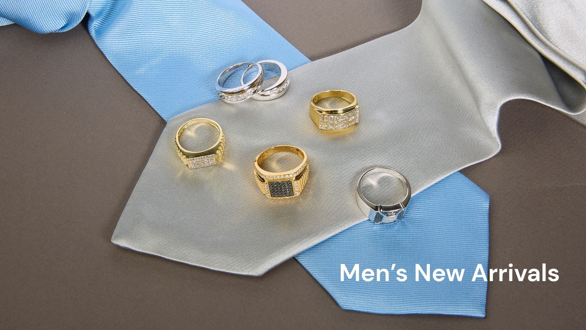Gold and silver rings on a blue tie with 'Men's New Arrivals' text.