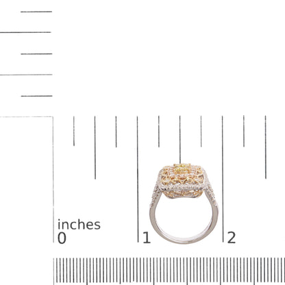 Ring with yellow, white, and rose metal tones featuring round prong-set red and white gemstones, shown from the side on a ruler for size reference.