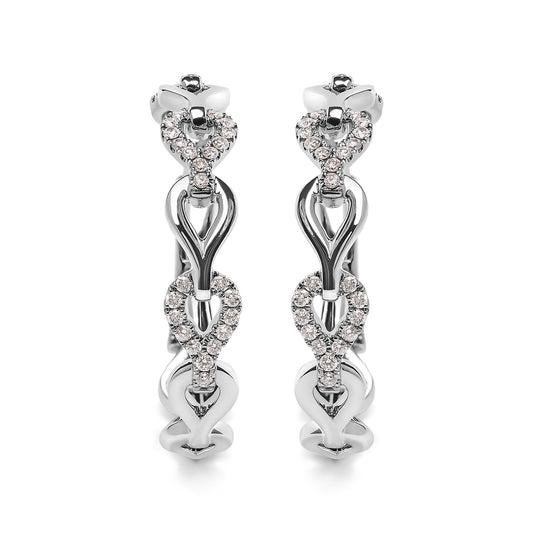 Front angle view of white metal hoop earrings with alternating plain and white gemstone-studded heart-shaped links.