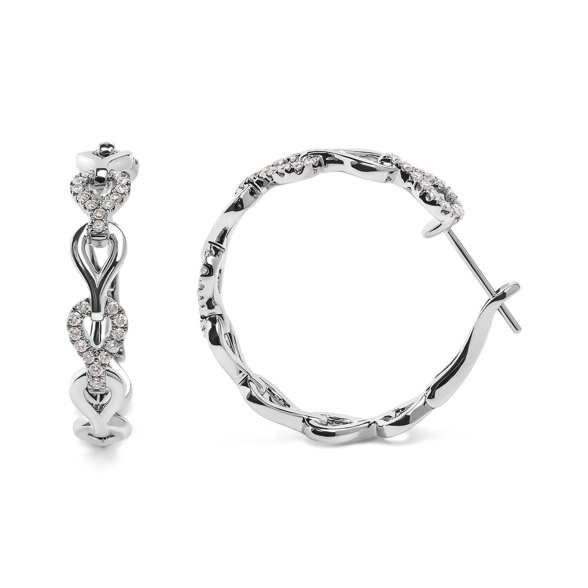 White metal hoop earrings with intertwined heart shapes accented with round white gemstones, shown in front and side views on a white background.