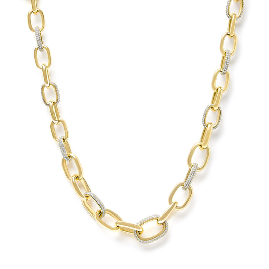 Close-up front angle of a yellow necklace featuring elongated chain links, some adorned with pave-set white gemstones.