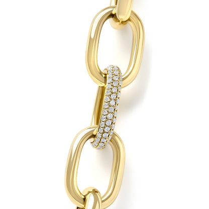Close-up front angled view of a yellow metal necklace with large oval links, one link set with multiple rows of white round pave gemstones.
