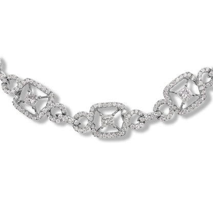 Close-up front angle of a white metal necklace featuring alternating princess-shaped and round-shaped white gemstones in prong settings, connected by round gemstone-encrusted links.
