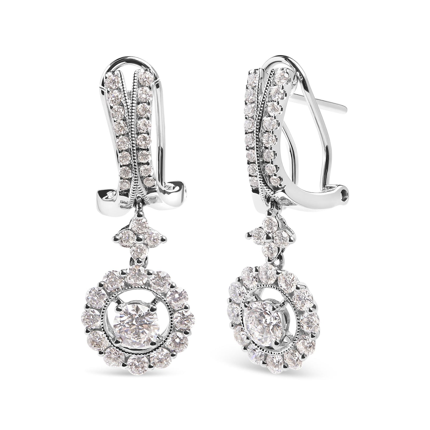 Front angle view of white metal drop earrings with clusters of round white gemstones in prong settings, featuring two larger central gemstones surrounded by smaller gemstones.