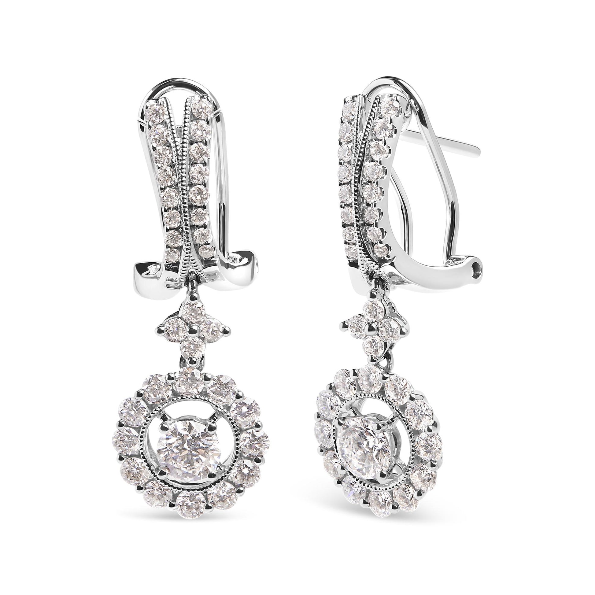 Front angle view of white metal drop earrings with clusters of round white gemstones in prong settings, featuring two larger central gemstones surrounded by smaller gemstones.