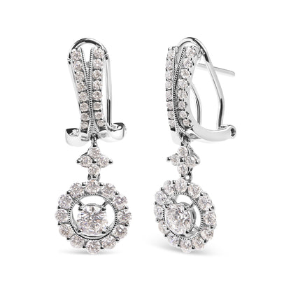 Front angle view of white metal drop earrings with clusters of round white gemstones in prong settings, featuring two larger central gemstones surrounded by smaller gemstones.