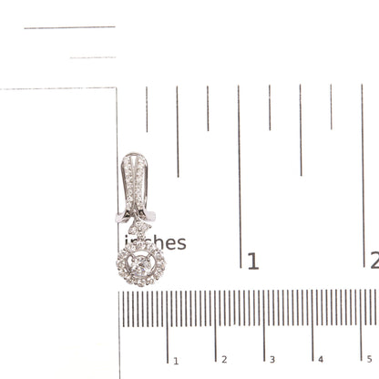 Single white metal earring with round white gemstones in prong setting, photographed from the front on a ruler for size reference.