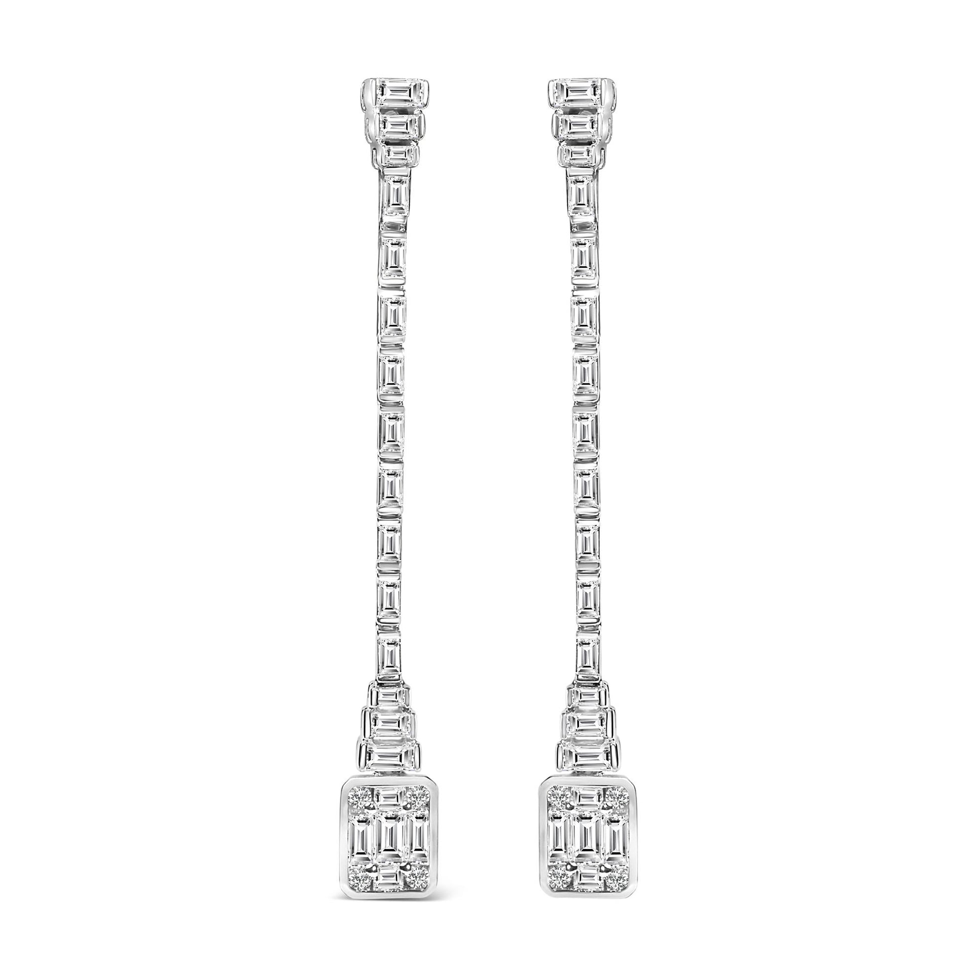 Front view of long white metal earrings featuring rows of rectangular channel-set white gemstones with clusters of round bezel-set white gemstones at the top and bottom.