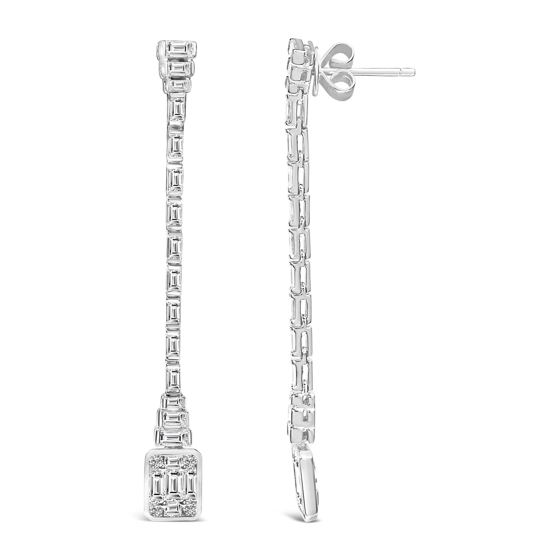 Front and side view of long white metal earrings featuring round bezel-set white gemstones at the bottom and channel-set baguette-shaped white gemstones along the entire length.
