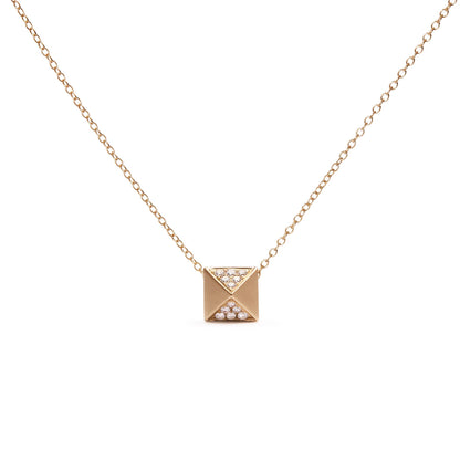 Front-facing shot of a yellow metal necklace with a square pendant featuring two triangular sections pavé set with small white gemstones.