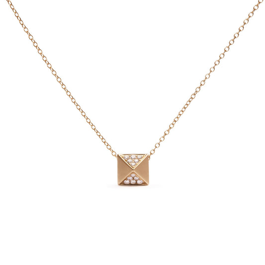 Front-facing shot of a yellow metal necklace with a square pendant featuring two triangular sections pavé set with small white gemstones.