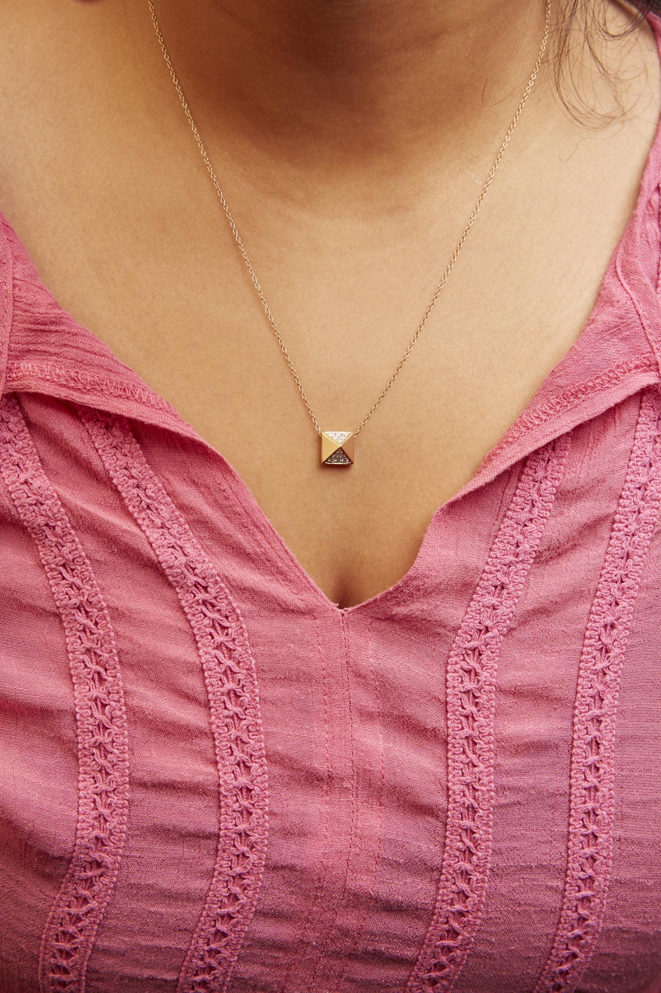 Close-up front view of a model wearing a yellow necklace with a square pendant featuring pave-set white round gemstones on two opposite corners.