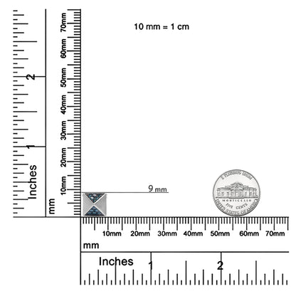White metal necklace pendant with triangular sections set with round blue gemstones, shown on a ruler for size reference, top-down angle.