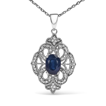 Front view of a white metal necklace with a pendant featuring an oval blue gemstone surrounded by intricate detailing of round white gemstones.