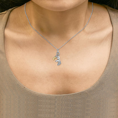 Necklace shown worn on a model featuring a yellow metal crescent charm and a silver-tone charm with white gemstones, shot from the front.