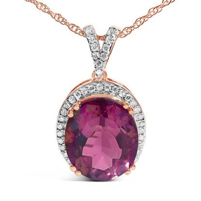 Close-up front view of a rose metal necklace pendant featuring an oval pink gemstone in a prong setting surrounded by a halo of small white round gemstones, also prong set.