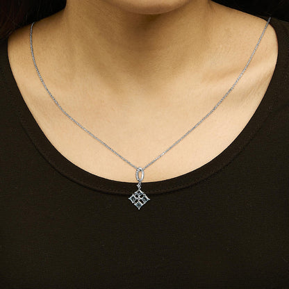 White metal necklace with a pendant featuring four square blue gemstones arranged in a diamond shape, surrounded by several small round white gemstones, shown worn on a model in a front close-up view.