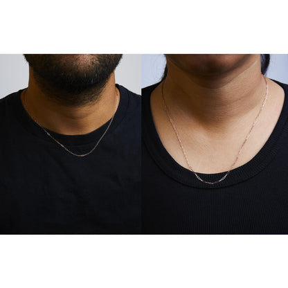 Side-by-side images showing a rose-colored chain necklace with elongated links worn by a male model on the left and a female model on the right, both shot from the front.