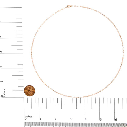 Rose-colored chain with elongated links displayed flat on a white background, shot from above with rulers and a coin for size reference.