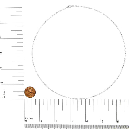 Top-down view of a white chain necklace placed flat on a ruler and scale for size reference.